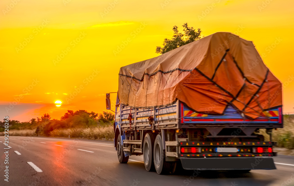 Obraz premium Truck with container on highway, cargo transportation concept.