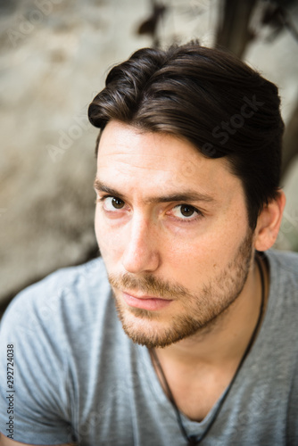 Portrait of young male model with serious face looking at camera, casual clothes.