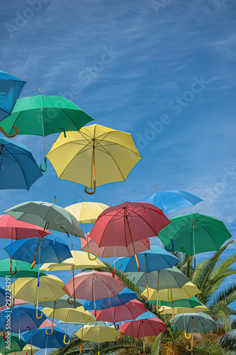 umbrella of different colors floating in the sky, copy-space photo