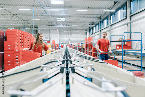 People working on sorting line in mail distribution center
