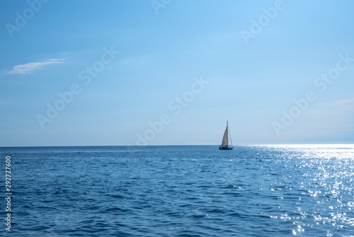 Sailing boat swimming in sea, blue sky © Natascha