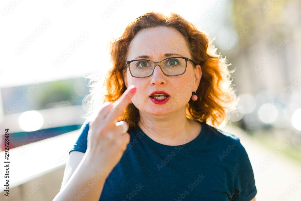 Angry woman showing obscene gesture. Angry woman showing obscene gesture.