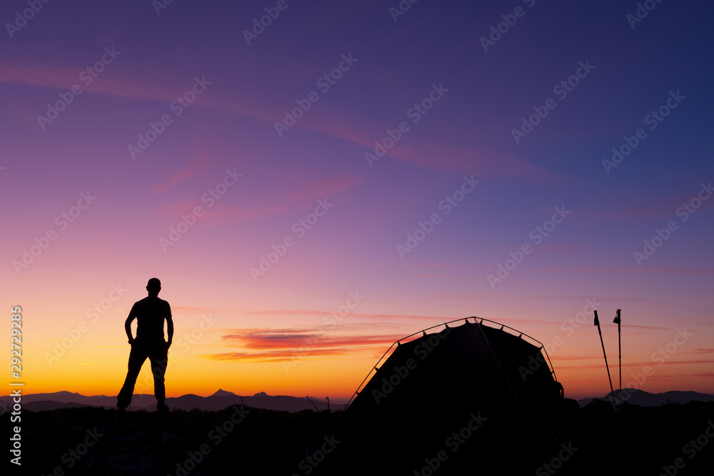 Mountaineer with tent at sunset in the Sierra de Aralar, Euskadi