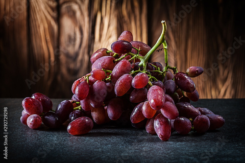 bunch of rose grape on vintage wooden background photo