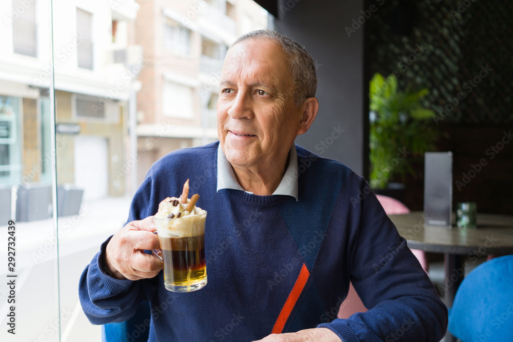 Handsome middle age senior man drinking coffee at restaurante, smiling happy enjoying and relaxing retirement