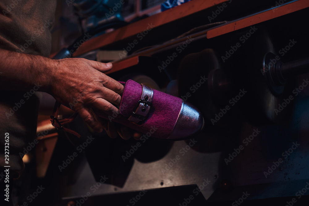 Experienced pensive person is making custom made shoes at his personal workshop. Experienced pensive person is making custom made shoes at his personal workshop.