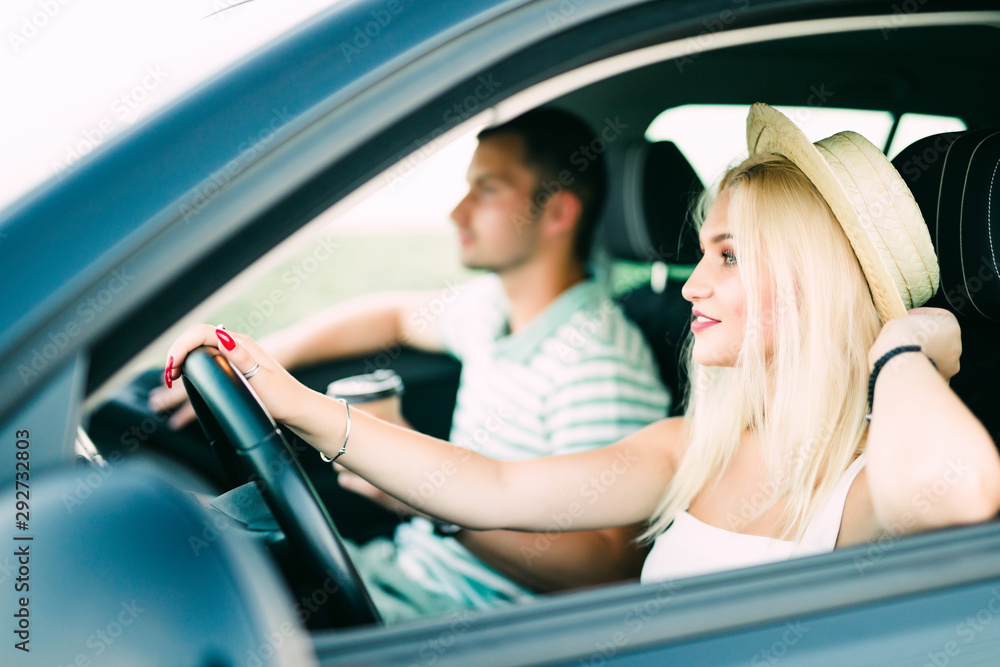 Leisure, road trip, travel, family and people concept, Happy man and woman driving in car