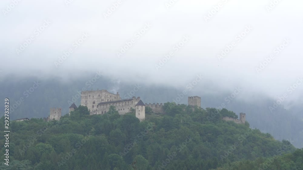 Stormy clouds rolling down the mountain with rain over the castle in Pergine Valsugana, close to Trento, Trentino, Italy. it is presumed to have been the seat of a Roman castelliere. Stormy clouds rolling down the mountain with rain over the castle in Pergine Valsugana, close to Trento, Trentino, Italy. it is presumed to have been the seat of a Roman castelliere.