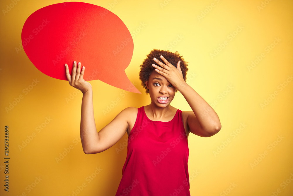 Young african american woman holding speech bubble over yellow isolated background stressed with hand on head, shocked with shame and surprise face, angry and frustrated. Fear and upset for mistake. Young african american woman holding speech bubble over yellow isolated background stressed with hand on head, shocked with shame and surprise face, angry and frustrated. Fear and upset for mistake.