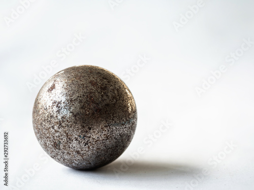 real aged steel ball with shadow on white