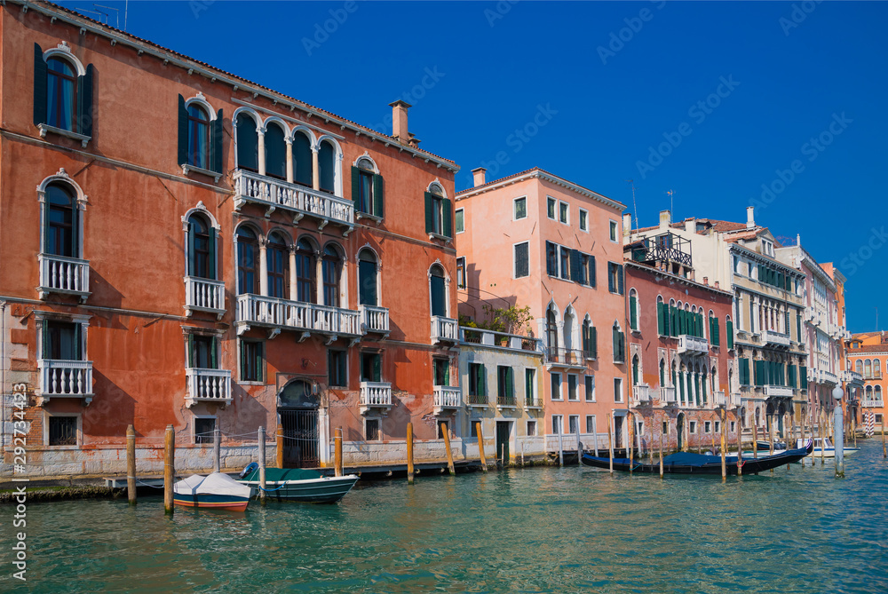 View of Venice from the Grand Canal. Venetian old colorful buildings against blue sky. Boat trip through the canals of Venice.