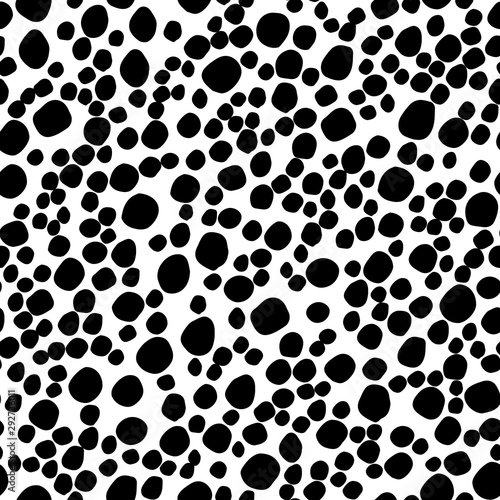 Abstract seamless pattern with black circles. Polka dot pattern. Animal print. Vector hand drawn texture with different sized circles. Illustration for wrapping paper, textile print.
