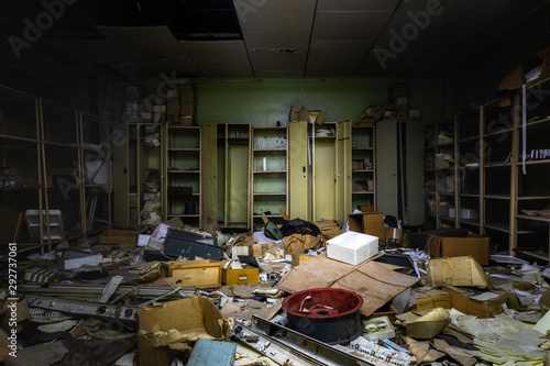 Messy room in abandoned building with lot of junk photo