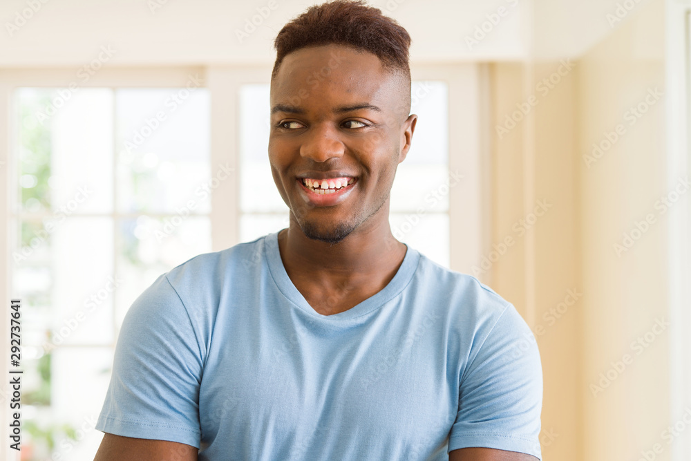 Handsome african young man smiling cheerful with crossed arms