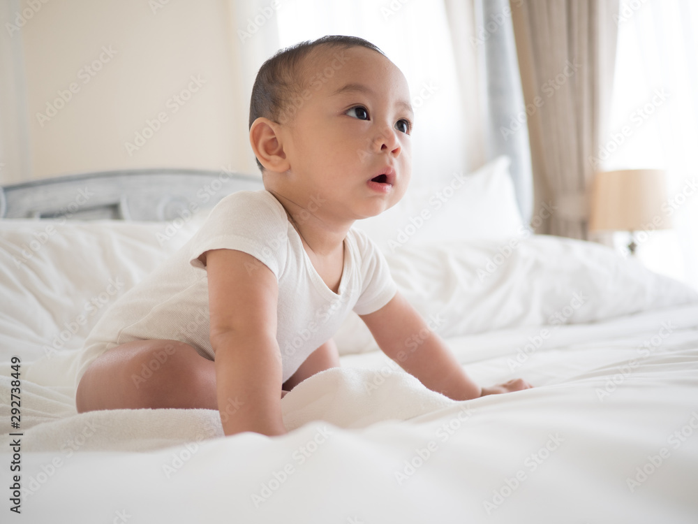 cute asian seven-month baby in white dress smiling