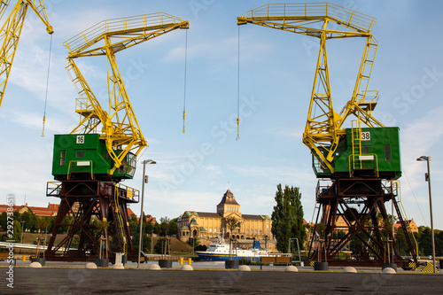 Two cranes and a historic building between them