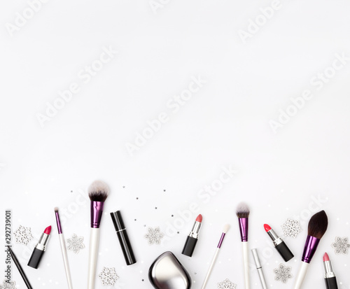 Women's accessories, cosmetics and makeup tools with Christmas decorations on a white background