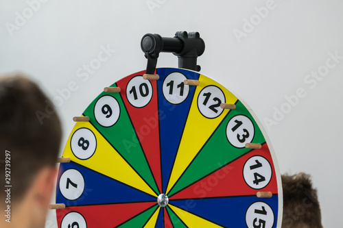 Young people gamble on the Wheel of Fortune and hope for the right lot. Concept: addiction or gambling