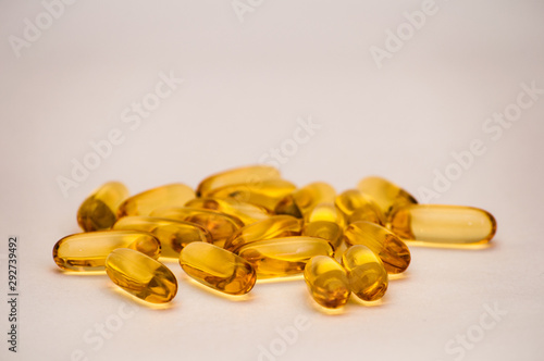 Close up of food supplement oil filled capsules suitable for: fish oil, omega 3, omega 6, omega 9, evening primrose, borage oil, flax seeds oil, vitamin A, vitamin D, vitamin D3, vitamin E.