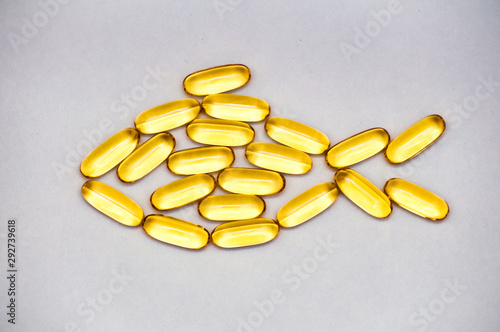 Omega 3 fish oil capsules - fish shape, isolated on white background. Top view, copy space, high resolution product. Health care concept