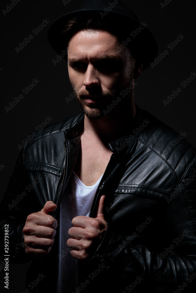 fashion model wearing leather jacket and black hat fashion model wearing leather jacket and black hat