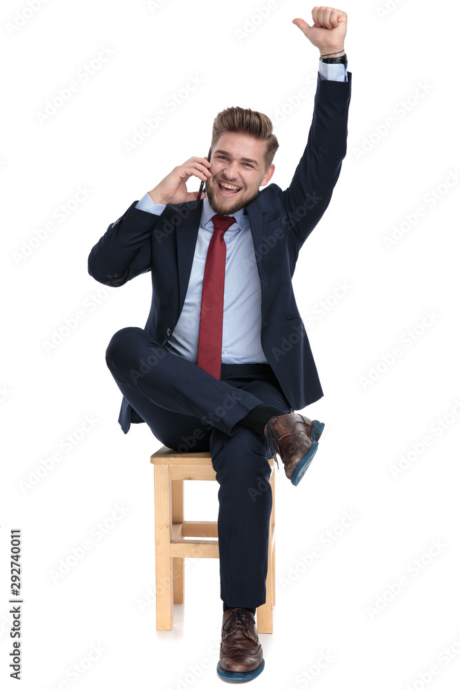 excited young businessman talking on the phone excited young businessman talking on the phone