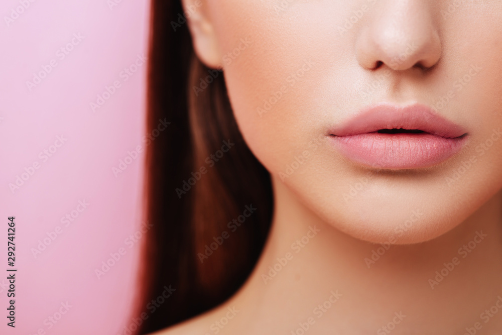Lips of Beauty cute fashion model with natural make up on pink background Lips of Beauty cute fashion model with natural make up on pink background