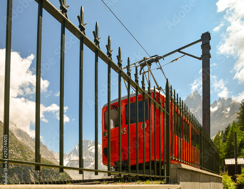 Low angle view of a red train departing from the rack railway station of Montenvers at the Mer de Glace in summer, Chamonix, Alps, France