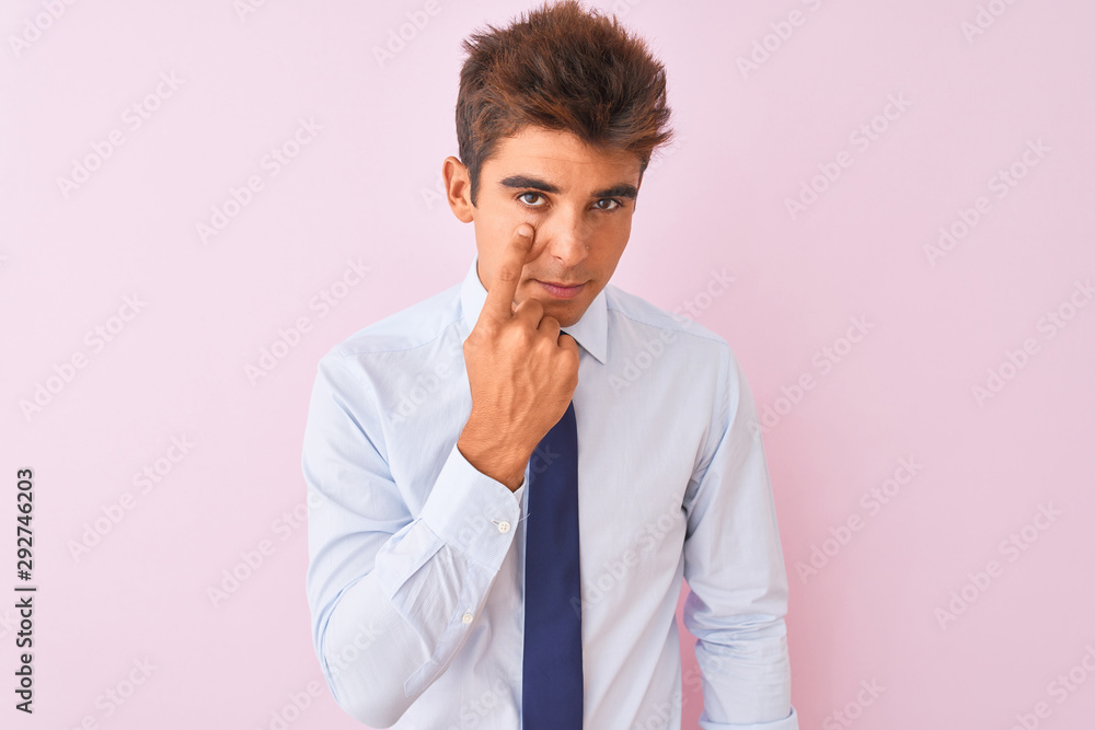 Young handsome businessman wearing shirt and tie standing over isolated pink background Pointing to the eye watching you gesture, suspicious expression Young handsome businessman wearing shirt and tie standing over isolated pink background Pointing to the eye watching you gesture, suspicious expression