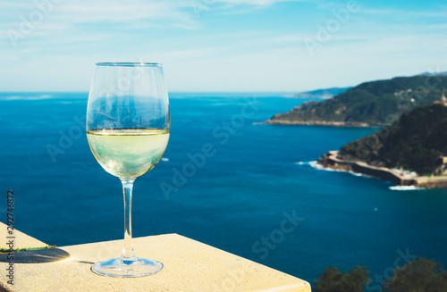 Drink glass white wine stand on blue sea top view city coast yacht from observation deck, romantic lonely toast with alcohol panoramic cityscape downtown, spain san sebastian vacation enjoy travel