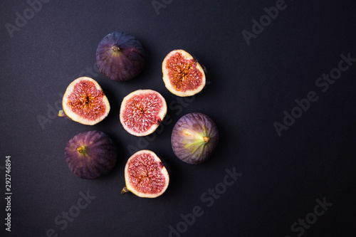 Fresh ripe figs on a dark table. Healthy Mediterranean figs. Fresh figs on black background. Beautiful blue purple Fig, selective focus photo