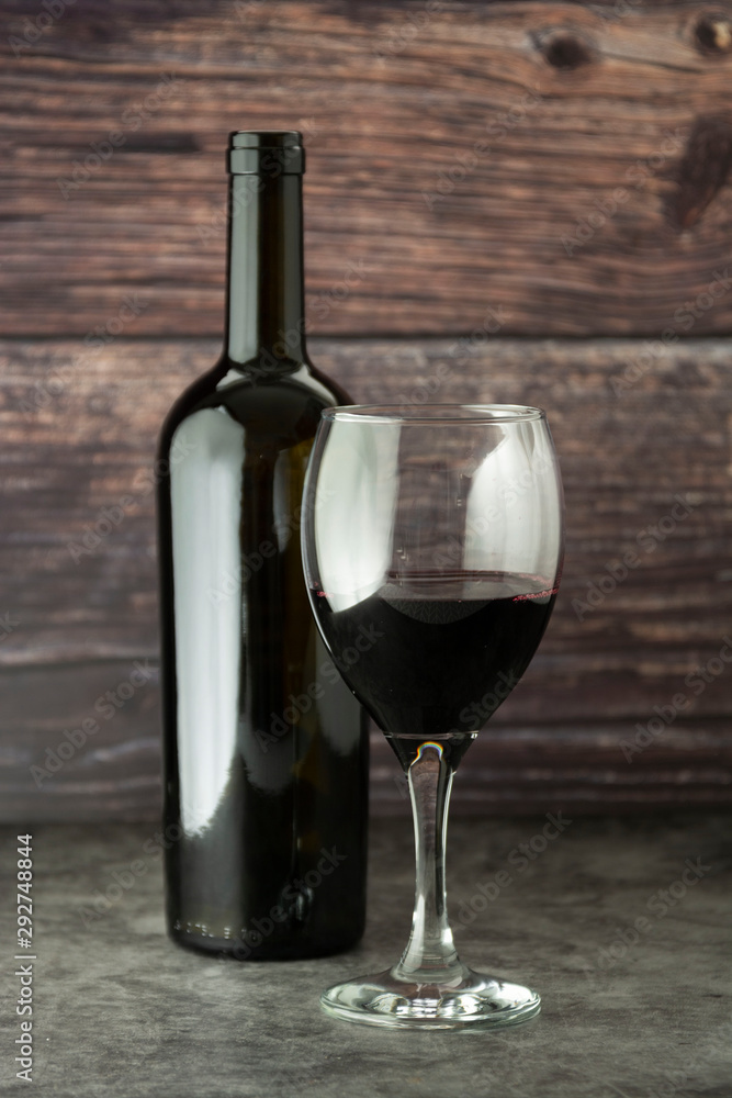 Wine bottle with wineglass corckscrew rustic wooden board, copy space.