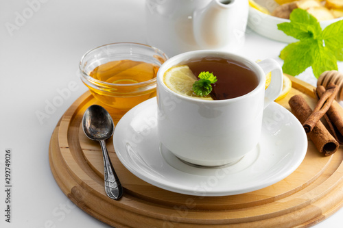 Cup tea with lemon and honey on a white background. Hot tea cup isolated, top view. Autumn, fall or winter drink. Copy space.