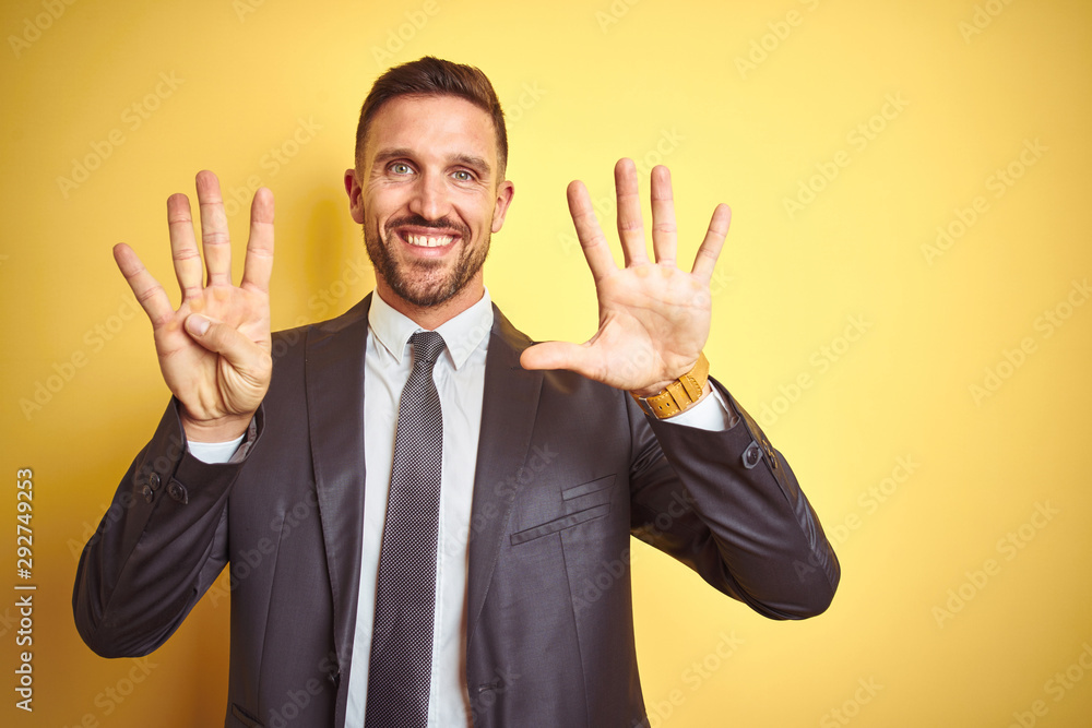 Young handsome business man over yellow isolated background showing and pointing up with fingers number nine while smiling confident and happy. Young handsome business man over yellow isolated background showing and pointing up with fingers number nine while smiling confident and happy.