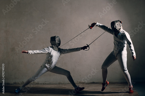 Fencer women with fencing sword.