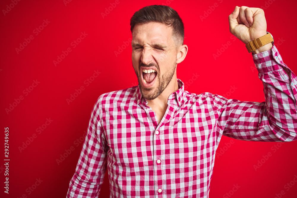 Young handsome man over red isolated background Dancing happy and cheerful, smiling moving casual and confident listening to music Young handsome man over red isolated background Dancing happy and cheerful, smiling moving casual and confident listening to music