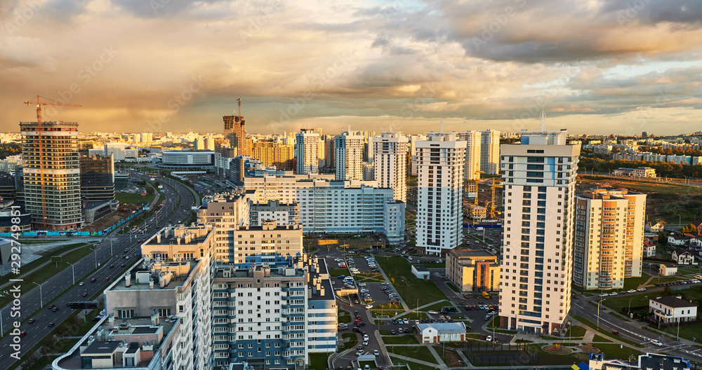 Fototapeta premium Panorama of urban district in rays of sunset light