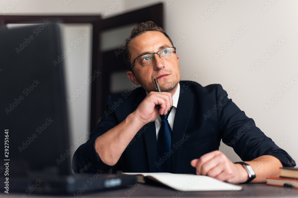 Sad man paying bills on his laptop Sad man paying bills on his laptop