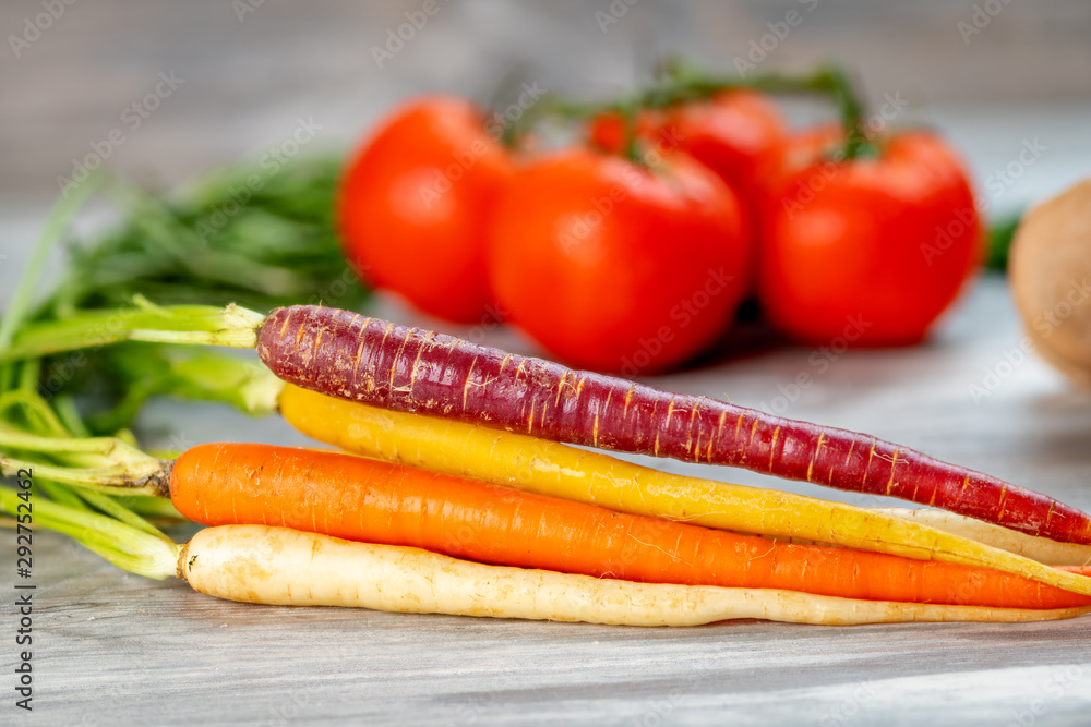 Close up of carrots along with other vegetables in the background Close up of carrots along with other vegetables in the background