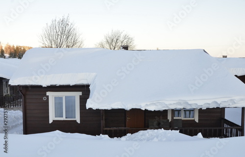Winter fairy tale. Village house in the white snow.