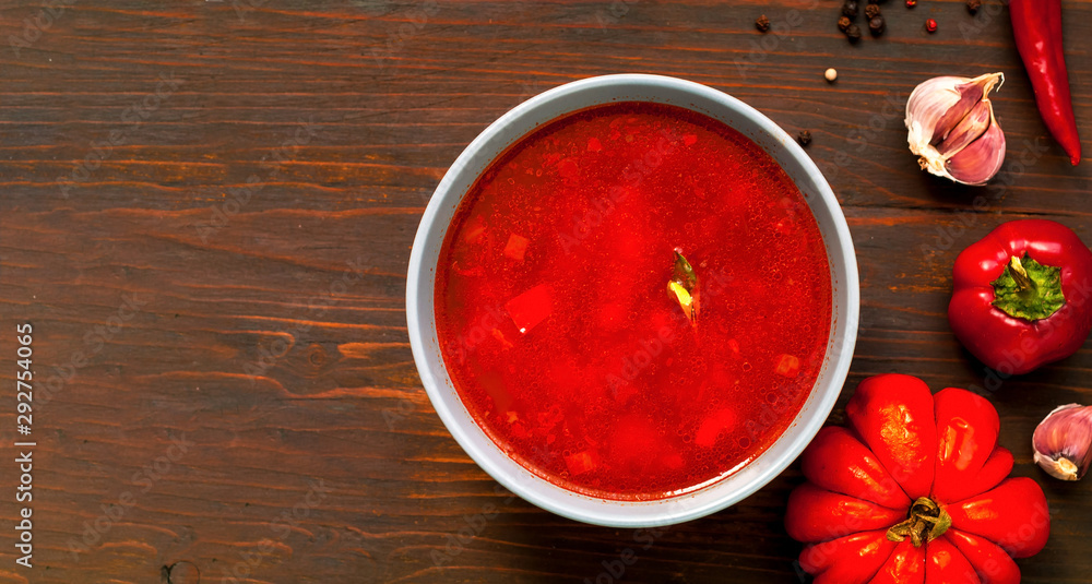 Mexican soup with chili pepper on wooden background. Close-up Mexican soup with chili pepper on wooden background. Close-up