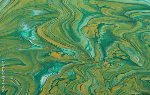 art photography of abstract marbleized effect background. emerald green, turquoise and gold creative colors. Beautiful paint.