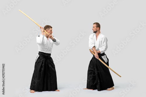 Two caucasian men are practicing aikido with Bokken (isolation path included)