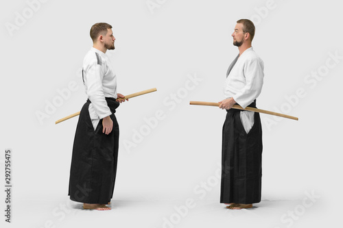 Two caucasian men are practicing aikido with Bokken (isolation path included)