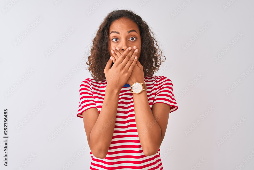 Young brazilian woman wearing red striped t-shirt standing over isolated white background shocked covering mouth with hands for mistake. Secret concept. Young brazilian woman wearing red striped t-shirt standing over isolated white background shocked covering mouth with hands for mistake. Secret concept.