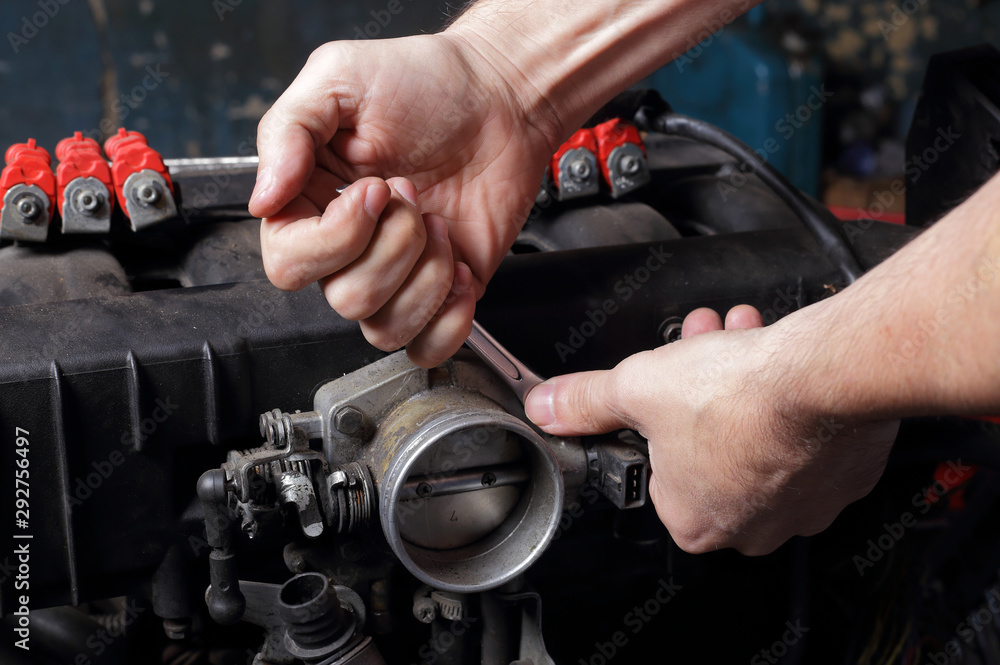 Car service - Engine repair mechanic hands with  wrench
