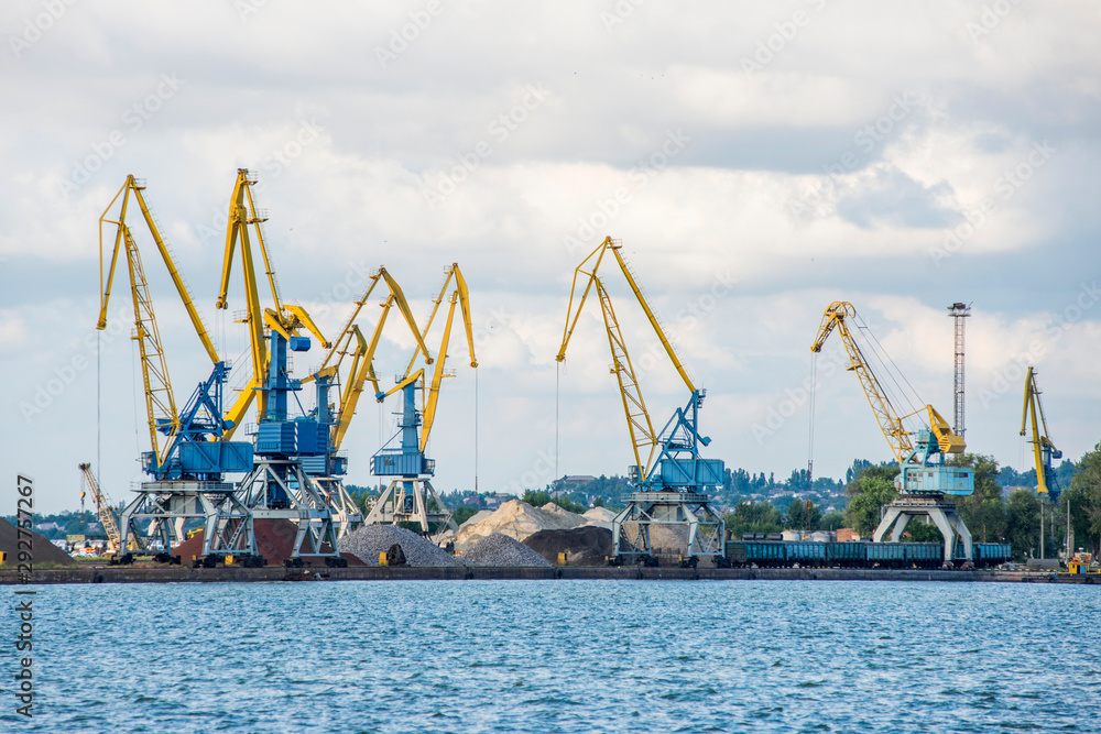 Cargo harbor in city. Loading port. Cargo terminal. Industrial cranes. Commercial docks with cranes