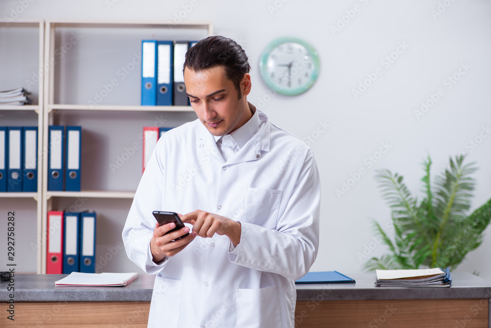 Young male doctor at the reception in the hospital Young male doctor at the reception in the hospital