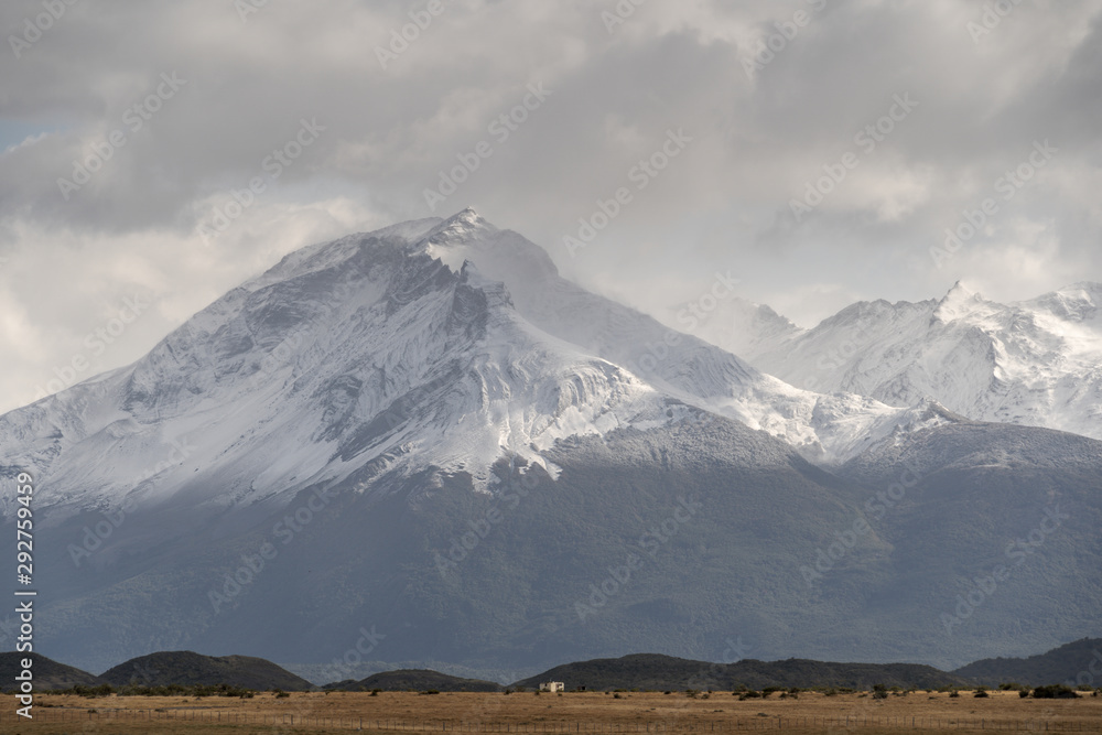Snowy mountain peak in moody weather. Puerto Natales, Provincia de Magallanes, Chile Snowy mountain peak in moody weather. Puerto Natales, Provincia de Magallanes, Chile