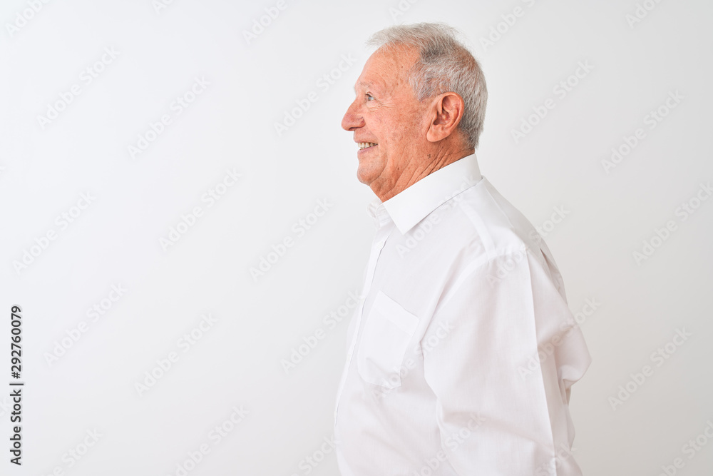 Senior grey-haired man wearing elegant shirt standing over isolated white background looking to side, relax profile pose with natural face with confident smile. Senior grey-haired man wearing elegant shirt standing over isolated white background looking to side, relax profile pose with natural face with confident smile.